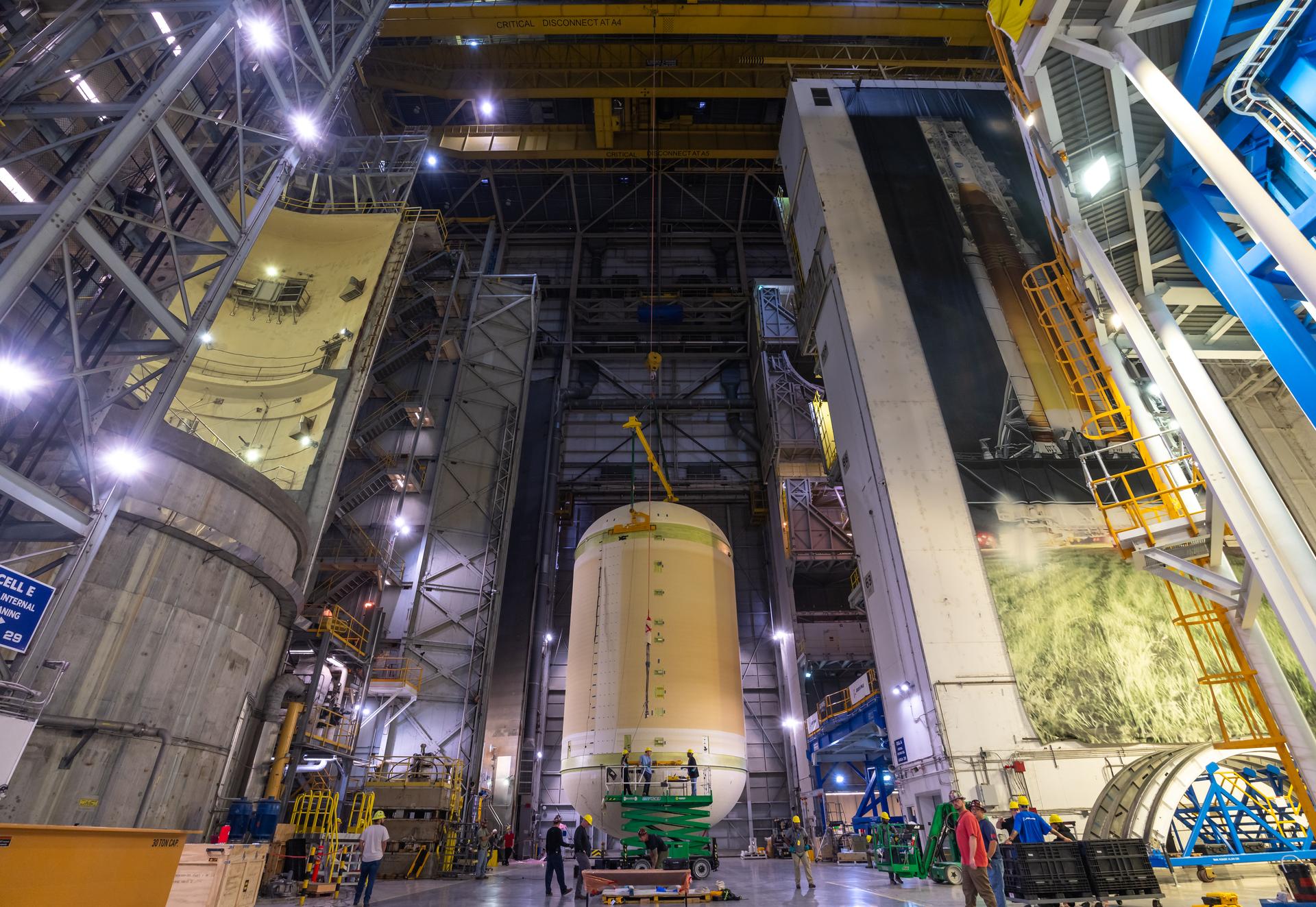 The liquid oxygen tank for NASA’s SLS (Space Launch System) rocket core stage for the Artemis III mission is lifted into a production cell at the agency’s Michoud Assembly Facility in New Orleans on Nov. 7. Move crews use an overhead crane system to lift the tank from the mobile transporter, which carried it from another area of the factory and set it atop the previously loaded intertank. Once the liquid oxygen tank is mated to the intertank, team will mate the stage’s forward skirt atop the tank to complete the forward join.   The propellant tank is one of five major elements that make up the 212-foot-tall rocket stage. The core stage, along with its four RS-25 engines, produce more than two million pounds of thrust to help launch NASA’s Orion spacecraft, astronauts, and supplies beyond Earth’s orbit and to the lunar surface for Artemis.